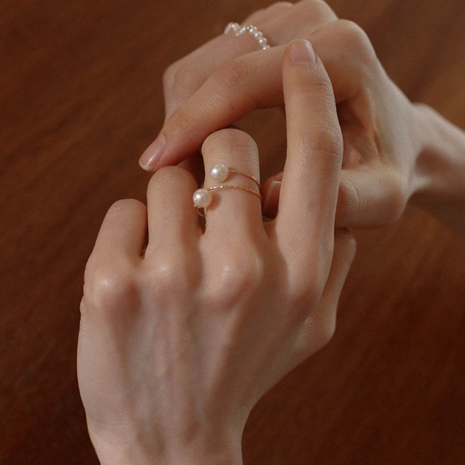 women wearing freshwater pearl rings with gold band